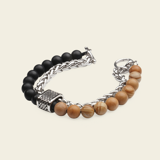 A men's beaded and chain bracelet featuring matte black beads, polished light brown wooden beads, and silver-tone metal chain links and clasp, displayed on a light beige background.