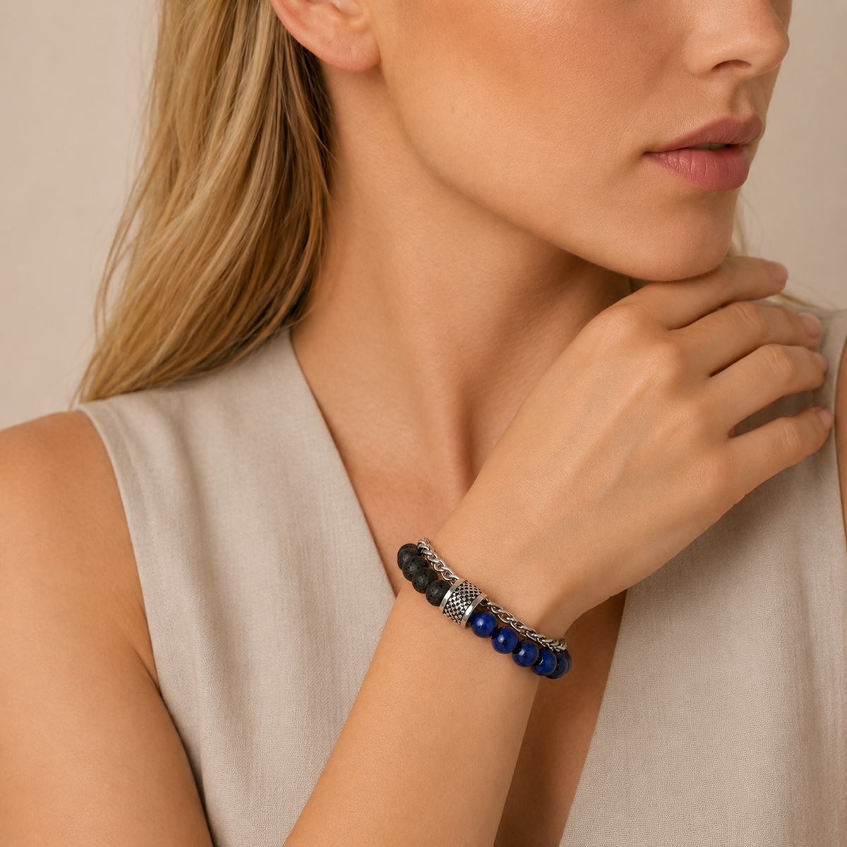 Woman wearing a bracelet with blue beads on a neutral background