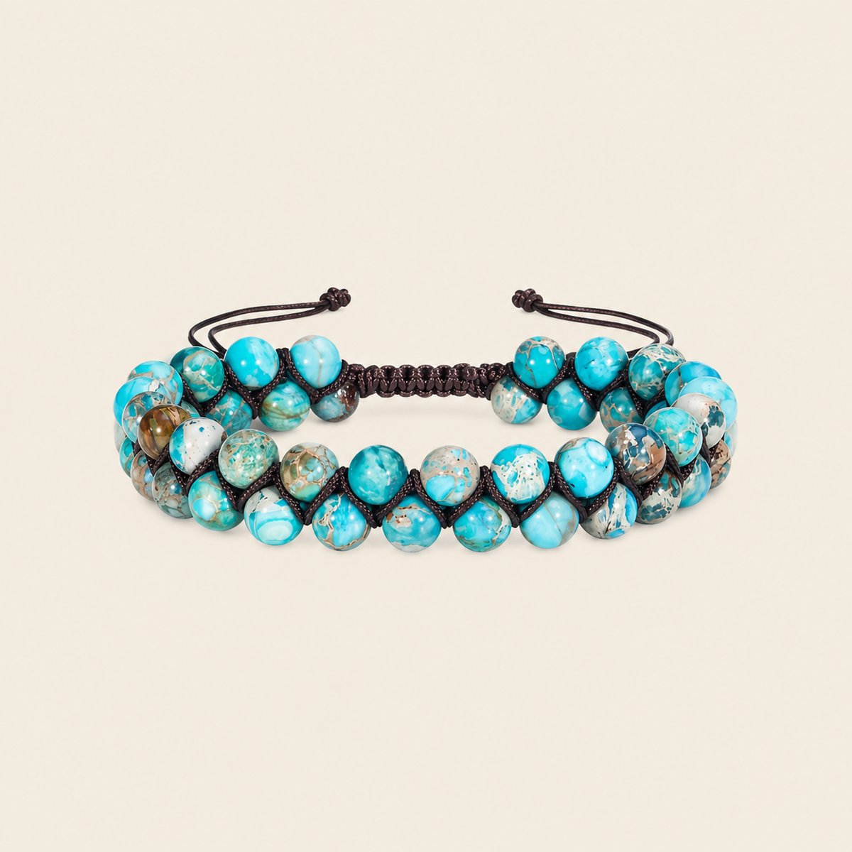 Turquoise beaded bracelet with black cord on a beige background