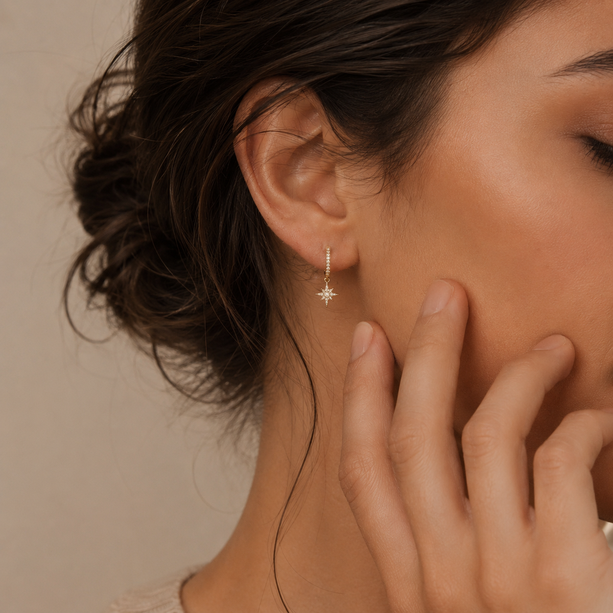 Close-up of a woman wearing a star-shaped earring with a blurred background