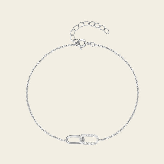 Silver bracelet on a light beige background