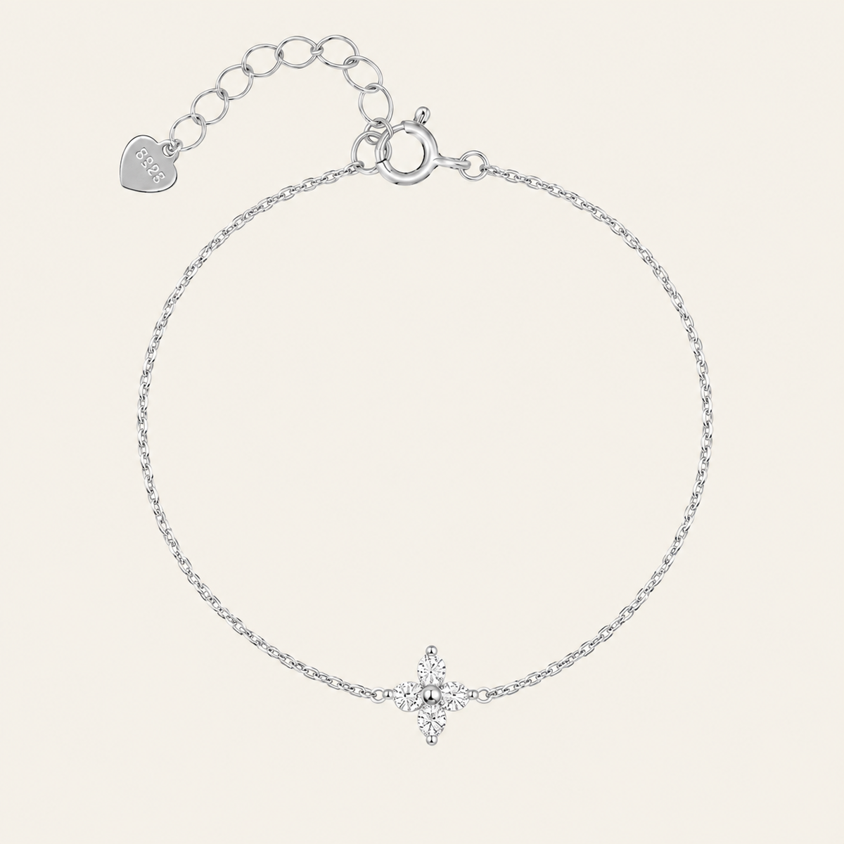 A delicate silver chain bracelet with a small star-shaped crystal charm at the bottom center, featuring an adjustable clasp with a heart-shaped tag engraved with 'LOVE'.