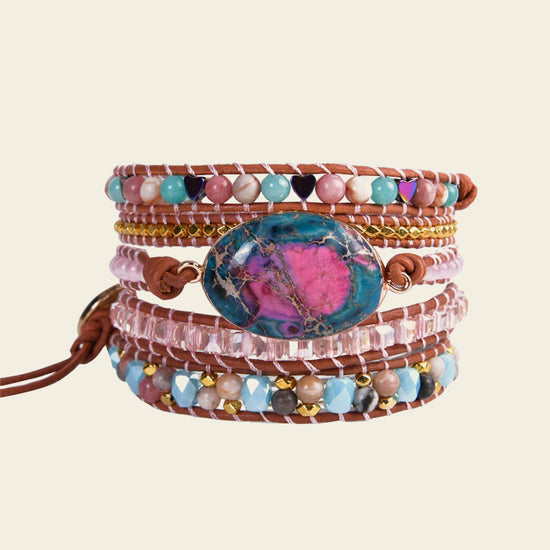 Multicolored beaded bracelet with a central stone on a beige background
