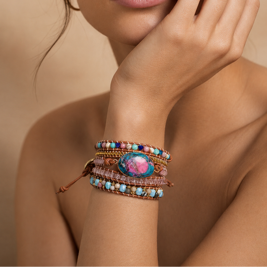 Close-up of a wrist wearing a colorful beaded bracelet against a neutral background