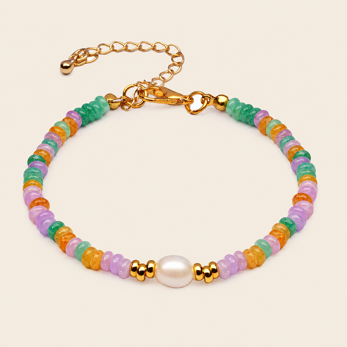 Multicolored beaded bracelet with gold accents on a beige background