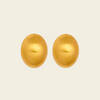 A pair of oval gold-toned stud earrings shown on a plain light beige background.