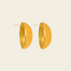 A pair of gold-toned geometric hoop earrings with a smooth outer half and a textured, dimpled inner half, shown on a light cream background.
