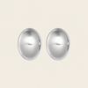 A pair of oval stud earrings with a polished, reflective silver finish, displayed against a solid, warm off-white background.