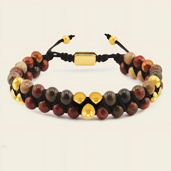 Bracelet with multicolored beads and gold accents on a beige background