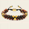 Bracelet with multicolored beads and gold accents on a beige background