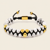 A beaded bracelet featuring white and gray marbled beads, polished gold-tone accent beads, and a black adjustable cord with a gold clasp, shown on a light beige background.