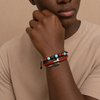Person wearing a bracelet with beads on a beige background