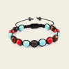 Multicolored beaded bracelet with a black clasp on a beige background