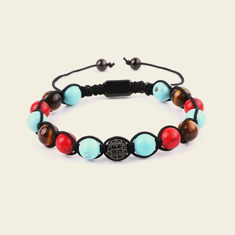 Multicolored beaded bracelet with a black clasp on a beige background