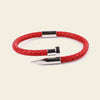 Red braided leather bracelet with silver clasp on a beige background