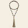 Beaded necklace with a tassel on a beige background