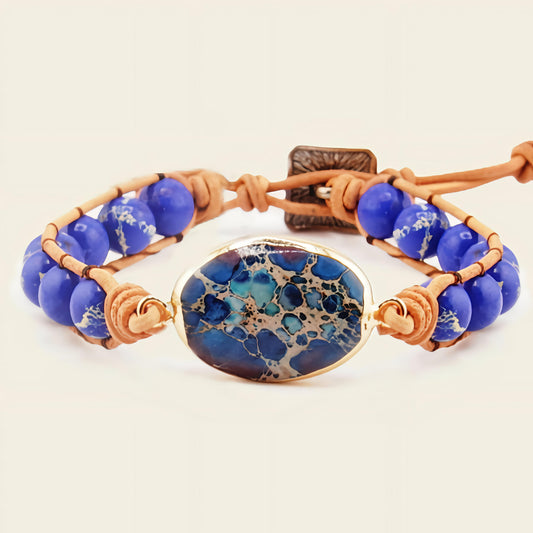 Bracelet with blue beads and a decorative stone on a beige background