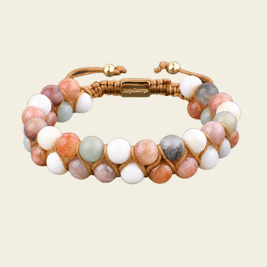 Bracelet with multicolored beads and gold accents on a beige background