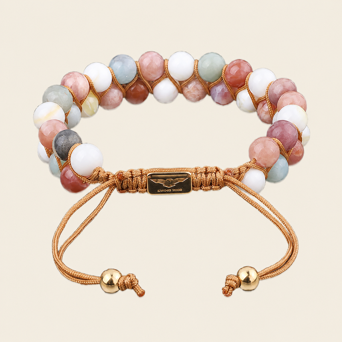 Multicolored beaded bracelet with gold accents on a beige background