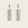 A pair of Silver drop earrings with a stacked, ribbed disc design, shown against a solid light beige background.
