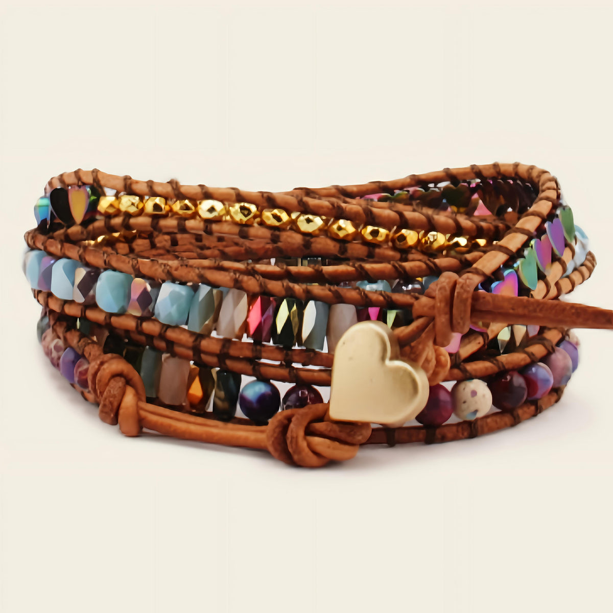 Multistrand beaded bracelet with a heart charm on a beige background
