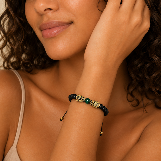 Close-up of a woman wearing a bracelet with beads on a neutral background