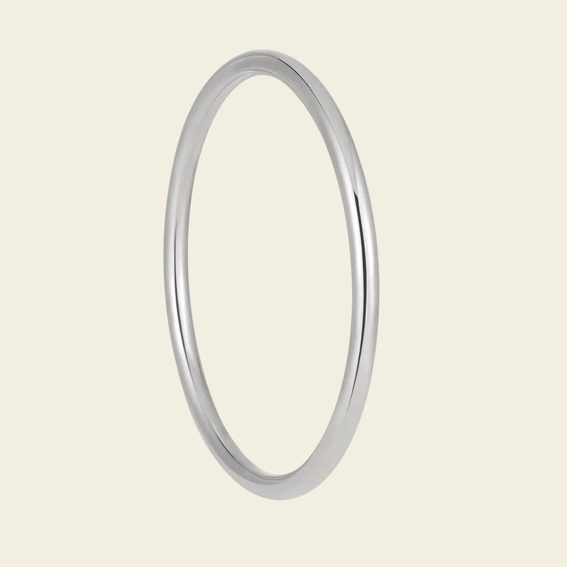 A minimalist, polished silver-toned metal bangle ring shown against a solid, warm off-white background.