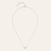 A delicate silver chain necklace with a small heart-shaped pendant set with clear stones, displayed on a light cream background.