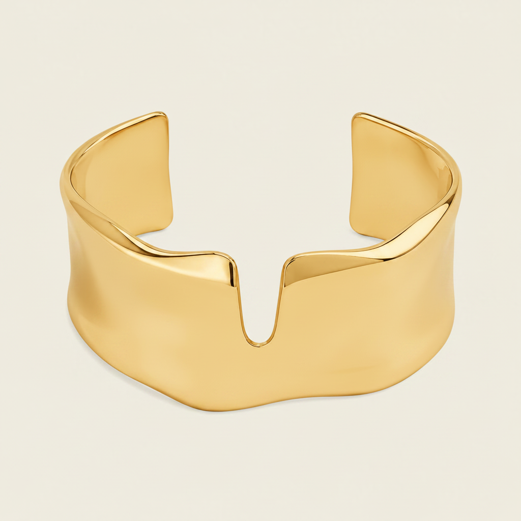 A polished silver cuff bracelet with a wide, sculptural, wavy profile and a central V-shaped notch, shown on a solid light beige background.