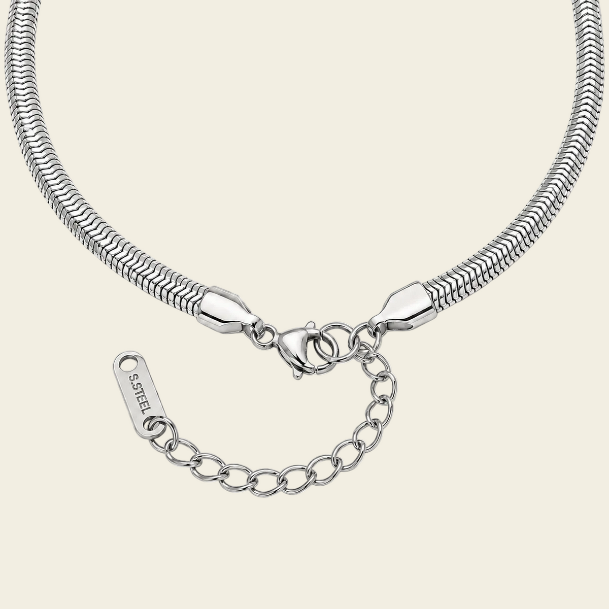 A close-up of a silver snake chain necklace with a lobster clasp, extender chain, and a branded tag engraved.