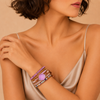 Woman wearing a bracelet with a neutral background