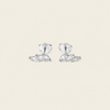 A pair of silver stud earrings with marquise-cut clear stones, displayed on a solid light beige background.