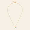 Gold necklace with a green pendant on a beige background