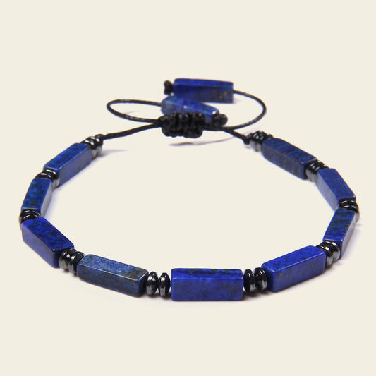 Blue beaded necklace on a beige background