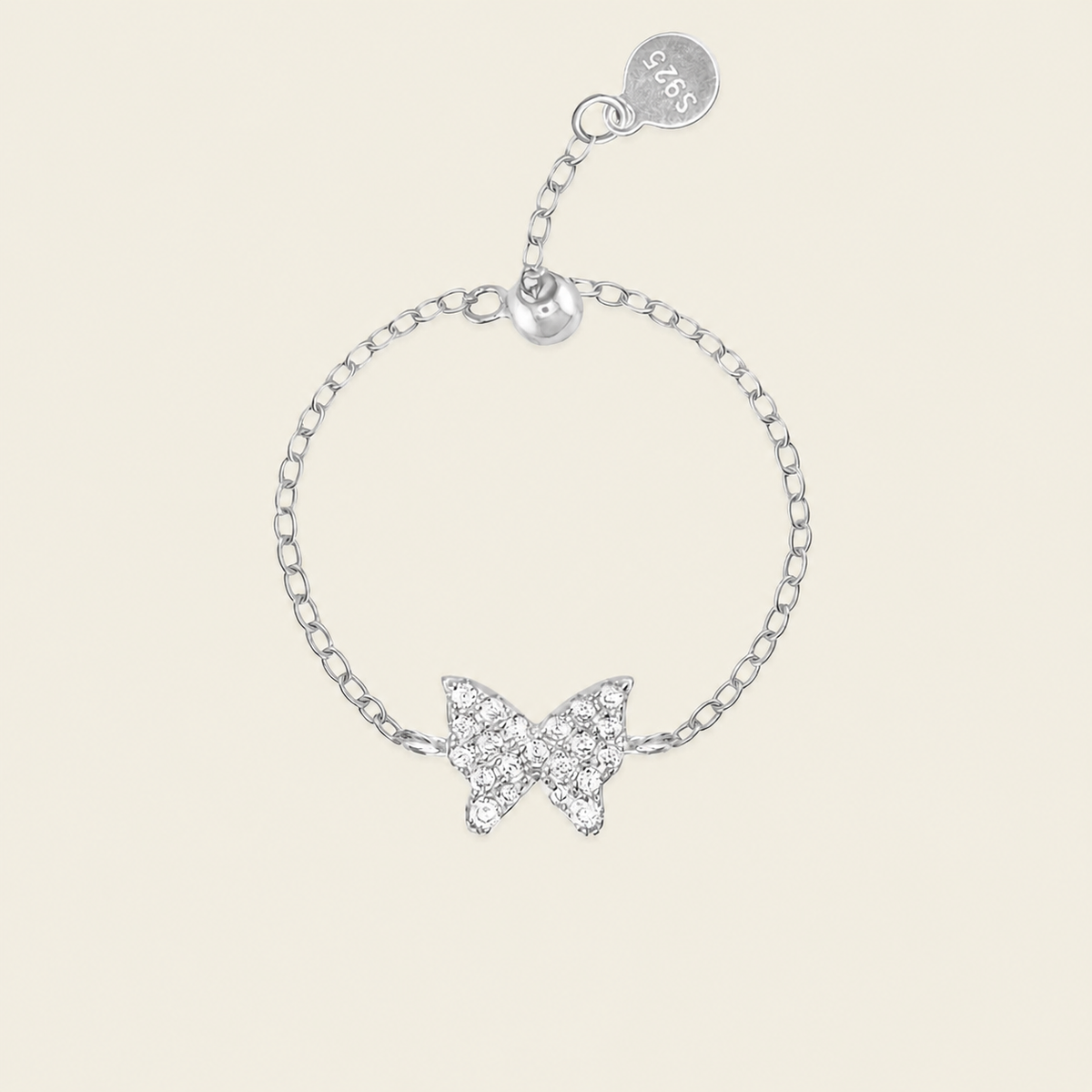 A silver chain bracelet featuring a butterfly-shaped charm paved with clear crystals, shown on a light beige background. The bracelet includes an adjustable lobster clasp with a round tag engraved with '925'.