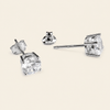 A pair of silver stud earrings with large clear square-cut gemstones, shown from multiple angles on a light beige background.