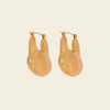 A pair of gold-toned, organic-shaped hoop earrings with a polished finish, displayed on a solid light beige background.