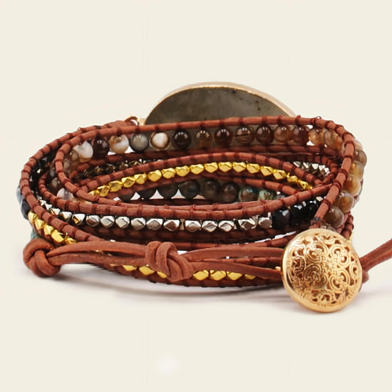 Multistrand leather bracelet with beads and decorative buttons on a beige background