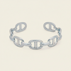 A polished chain-link cuff bracelet with interlocking oval links, shown on a clean off-white background.