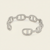 A chain link bracelet with a distinctive interlocking double-O design, displayed on a light cream background.
