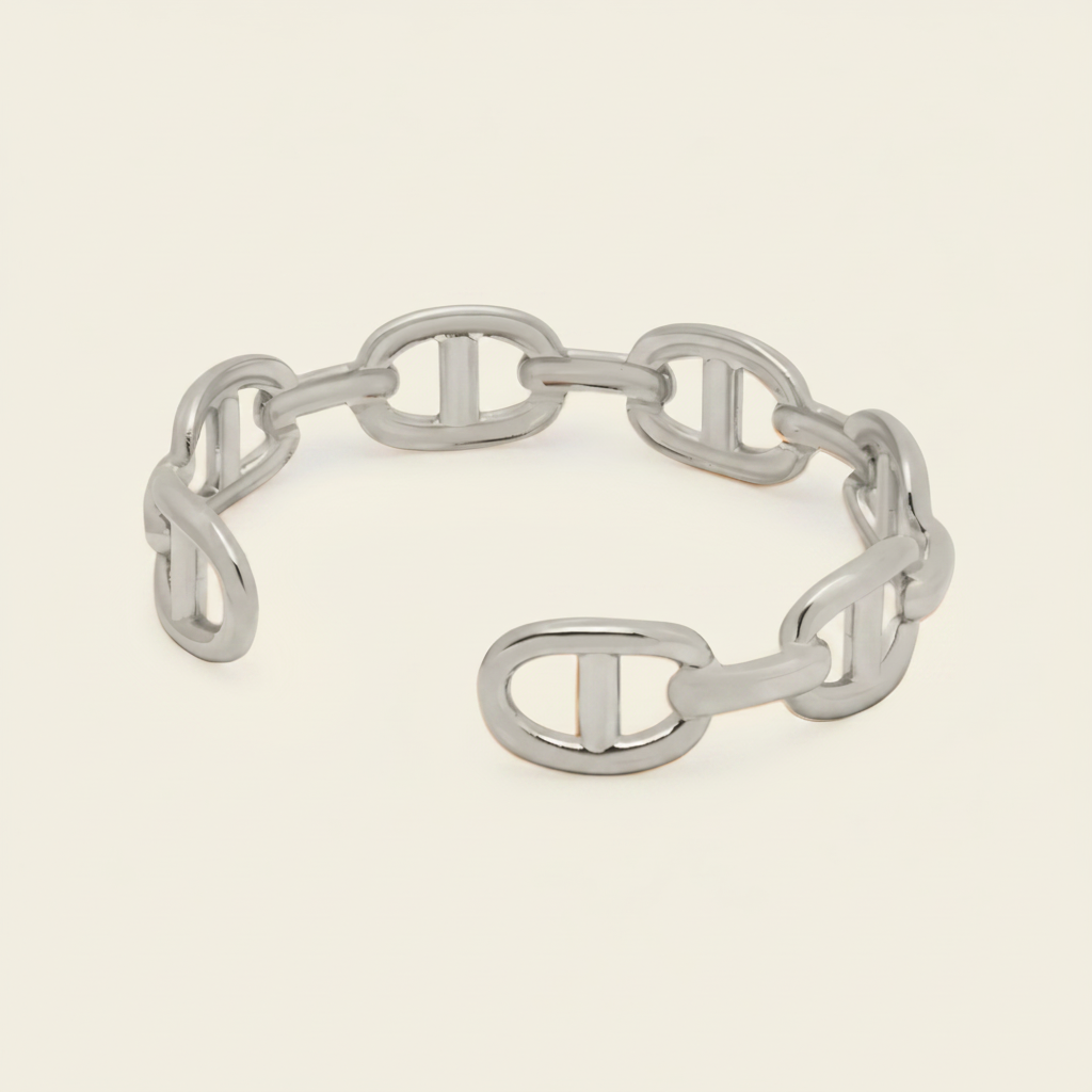 A chain link bracelet with a distinctive interlocking double-O design, displayed on a light cream background.