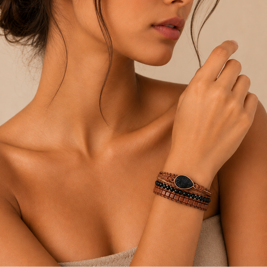 Close-up of a woman wearing a bracelet on a neutral background