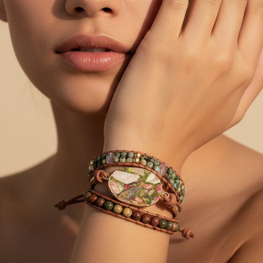 Close-up of a woman's wrist wearing a decorative bracelet with a neutral background