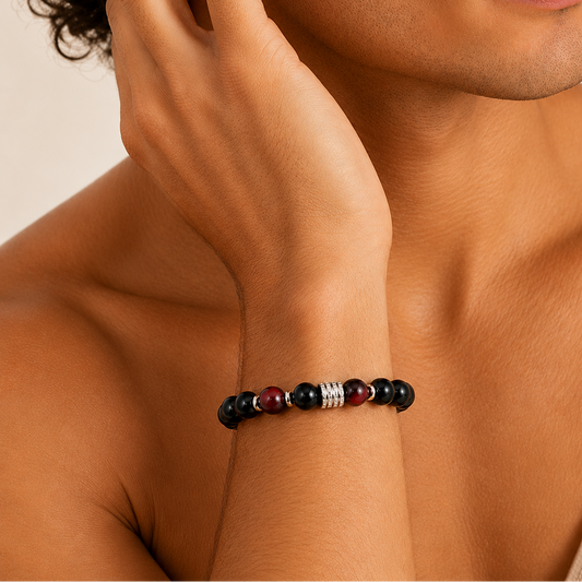 Close-up of a person wearing a beaded bracelet on a neutral background