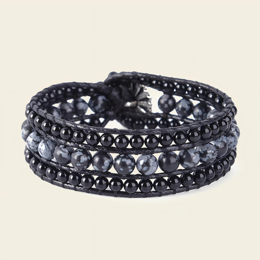 Black beaded wrap bracelet on a beige background