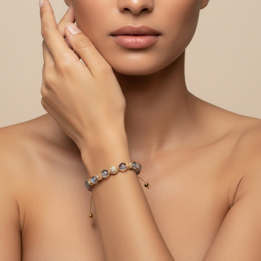 Woman wearing a delicate bracelet on a neutral background