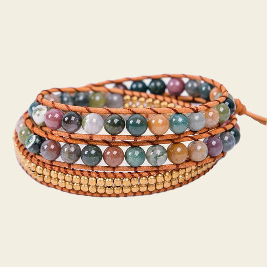Multicolored beaded bracelet with wooden accents on a beige background