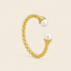 Gold ring with pearls on a beige background