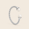 Silver ring with pearls on a beige background