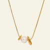 Gold necklace with a pearl pendant on a white background